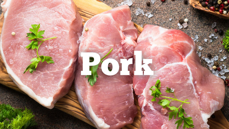 Slabs of raw pork on a wooden slab